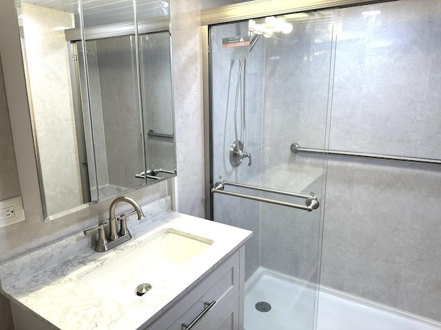 bathroom with an enclosed shower and vanity