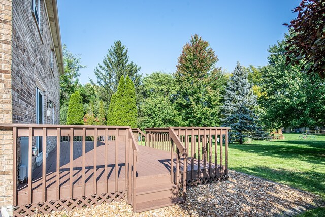 wooden deck featuring a yard