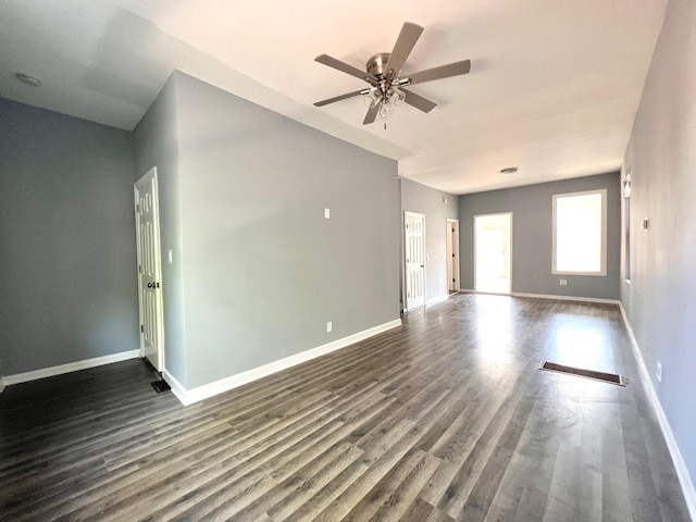 unfurnished room with ceiling fan and dark hardwood / wood-style floors