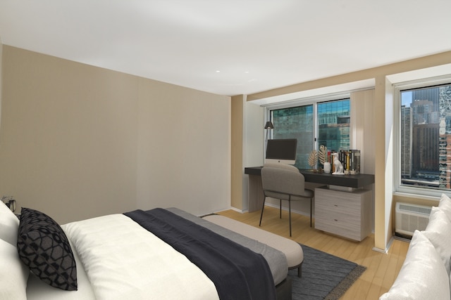 bedroom with an AC wall unit and light hardwood / wood-style flooring