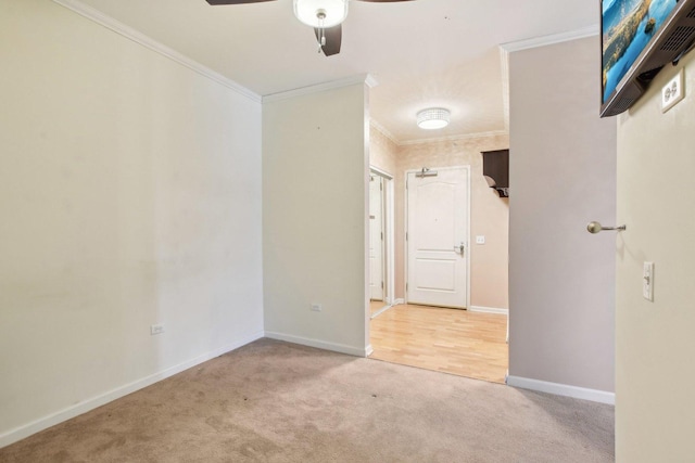 carpeted empty room with crown molding and ceiling fan