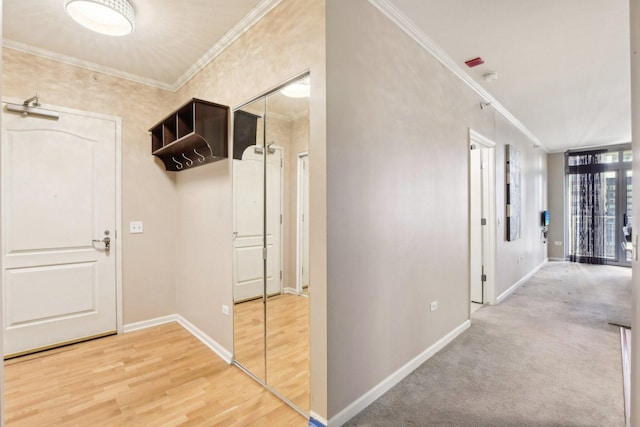 hallway with hardwood / wood-style flooring and crown molding