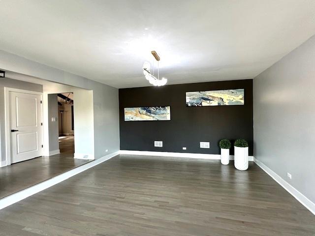 empty room with dark hardwood / wood-style flooring