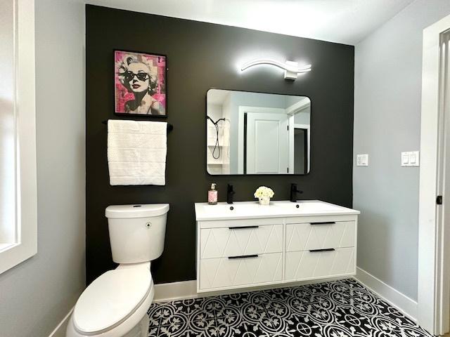 bathroom with vanity, tile patterned flooring, and toilet