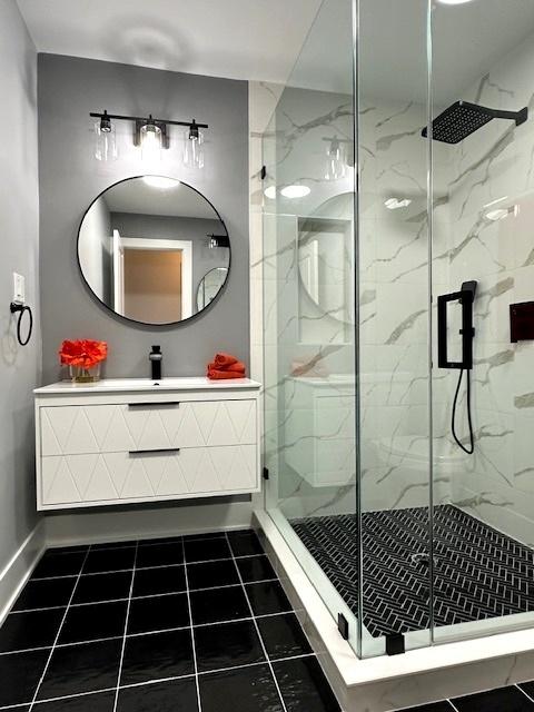 bathroom with vanity and a shower with door