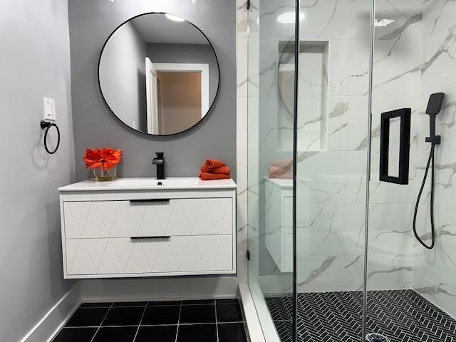 bathroom with vanity, tile patterned floors, and walk in shower