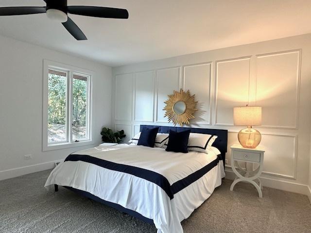 bedroom with ceiling fan and carpet