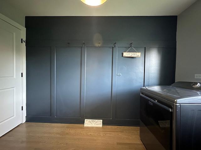 laundry area featuring washer / dryer and light hardwood / wood-style floors