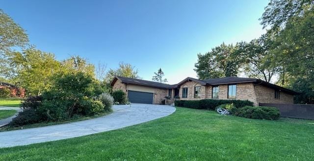 single story home featuring a garage and a front yard