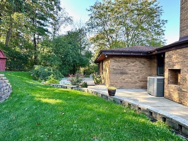 view of yard with a wooden deck and central AC