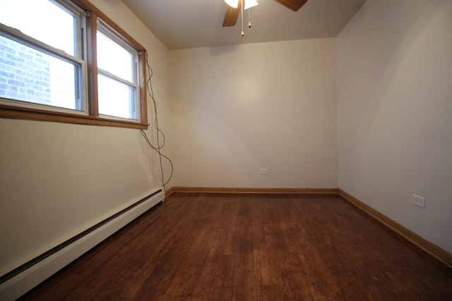 empty room featuring baseboard heating, ceiling fan, and dark hardwood / wood-style flooring