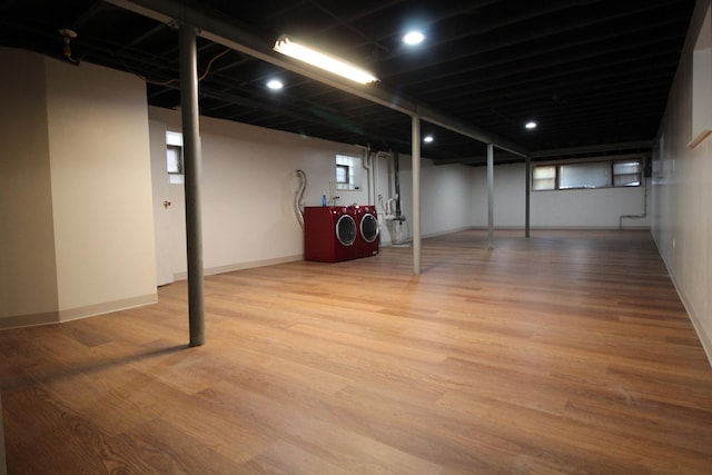 basement featuring washer and clothes dryer and wood-type flooring