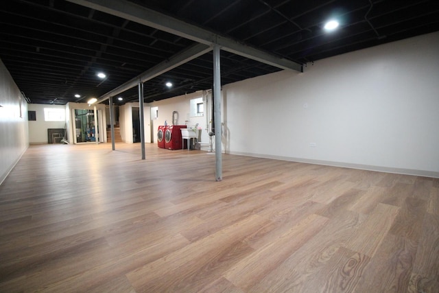 basement featuring sink and hardwood / wood-style floors