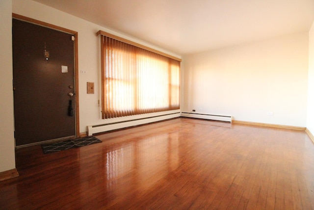 foyer with a baseboard heating unit and hardwood / wood-style flooring