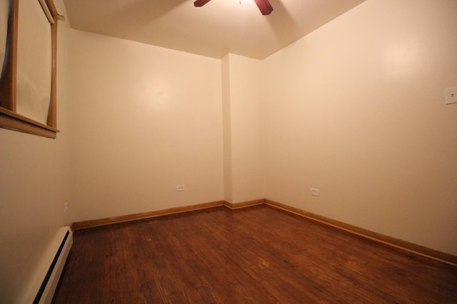 unfurnished room with baseboard heating, ceiling fan, and dark wood-type flooring