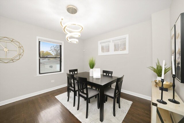 dining room featuring dark wood-type flooring and a chandelier