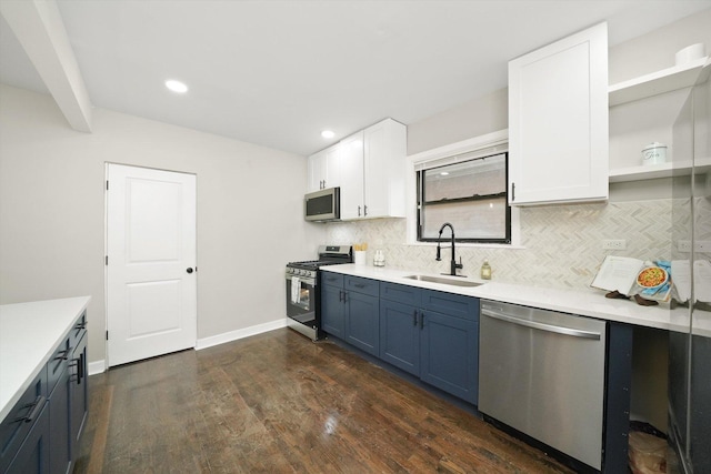 kitchen with dark hardwood / wood-style flooring, blue cabinetry, white cabinets, appliances with stainless steel finishes, and sink