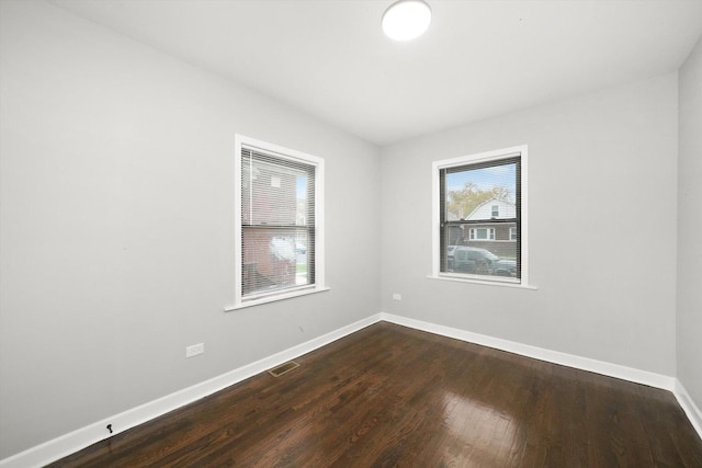 empty room featuring dark wood-type flooring