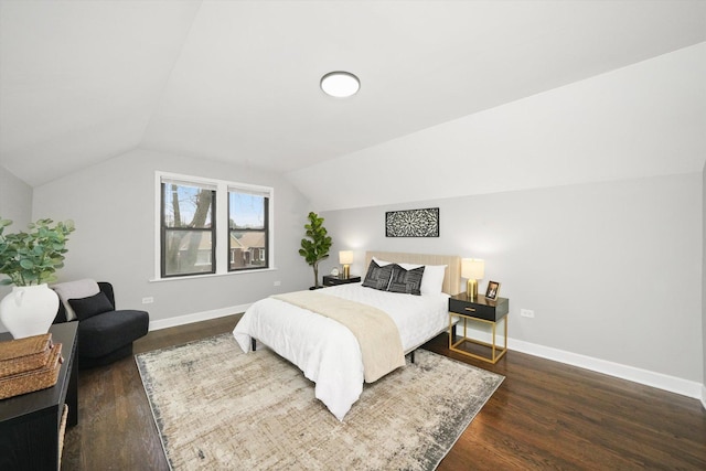 bedroom featuring lofted ceiling and dark wood-type flooring