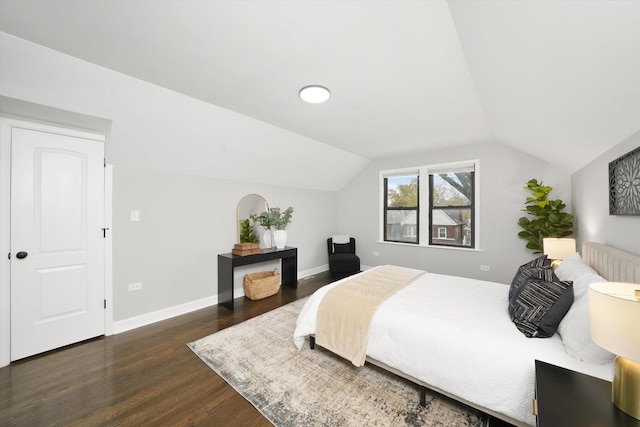 bedroom featuring vaulted ceiling, radiator, and dark hardwood / wood-style flooring