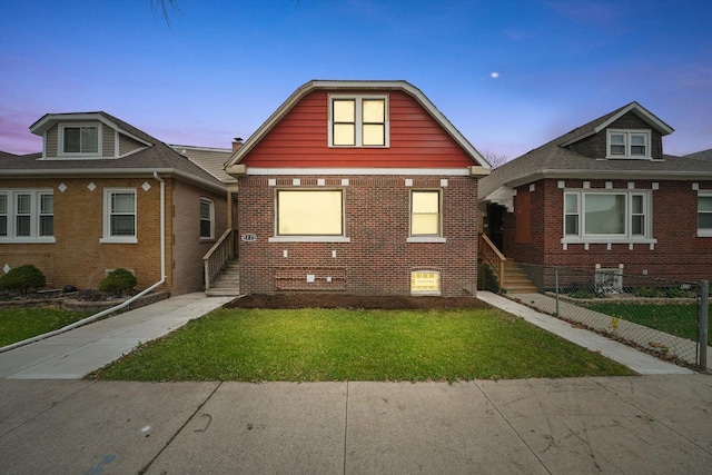 bungalow-style house with a yard