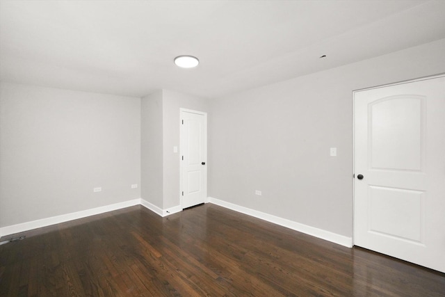 spare room featuring dark hardwood / wood-style flooring