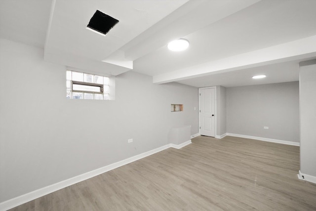 basement with light hardwood / wood-style flooring