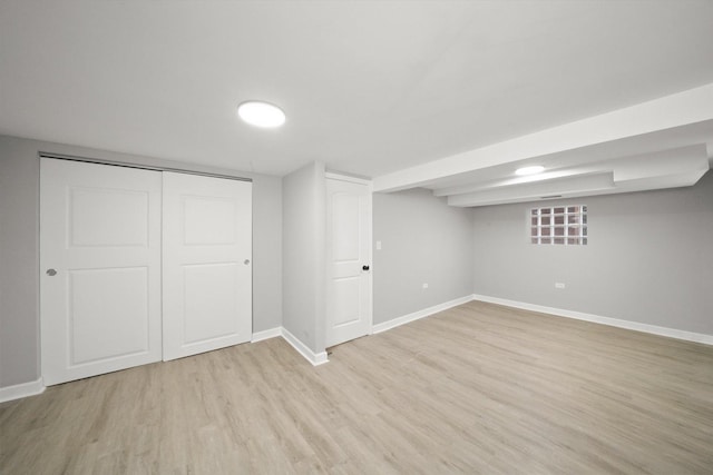 basement with light hardwood / wood-style flooring