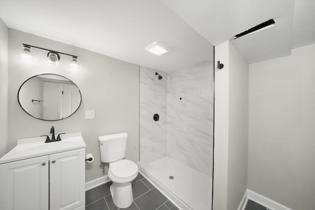 bathroom with toilet, tile patterned flooring, tiled shower, and vanity