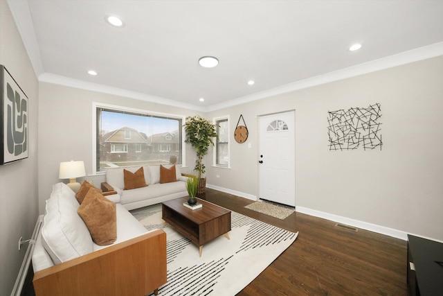 living room with dark hardwood / wood-style flooring and crown molding