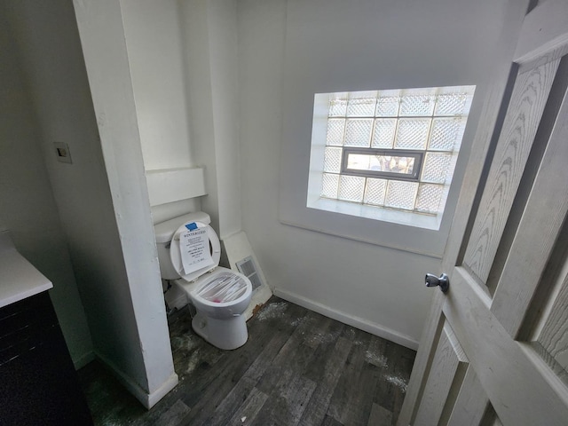 bathroom with toilet and wood-type flooring