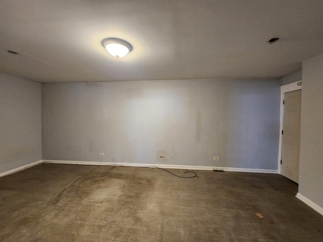 empty room featuring dark colored carpet