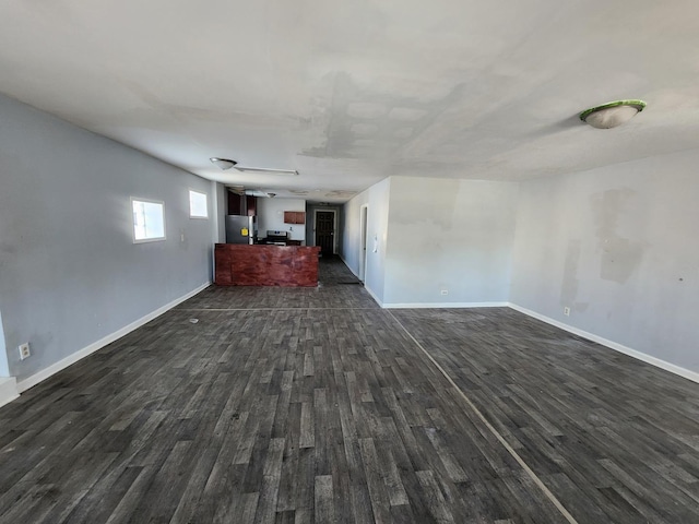 unfurnished living room featuring dark wood-type flooring