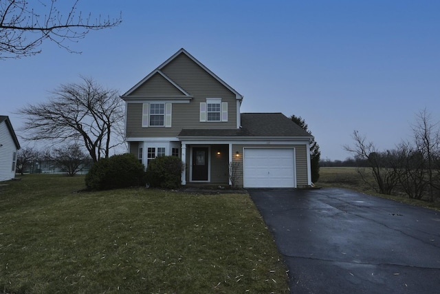 front of property with a front yard and a garage