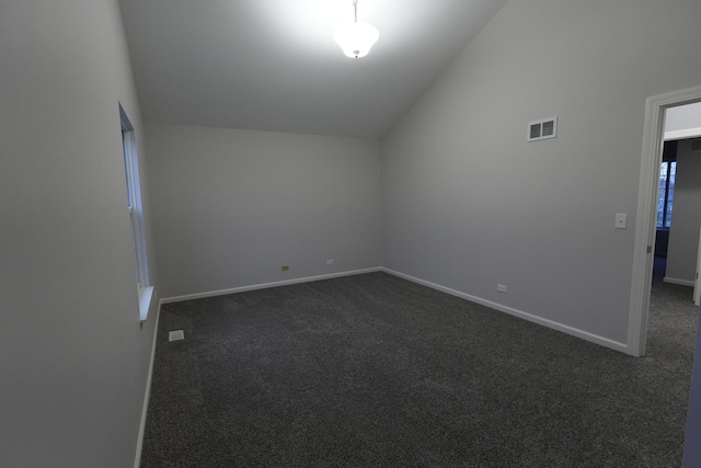 additional living space featuring high vaulted ceiling and dark carpet