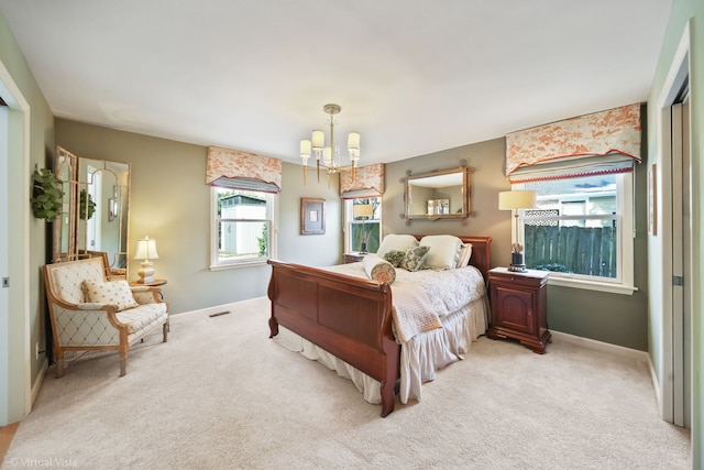 carpeted bedroom featuring a chandelier