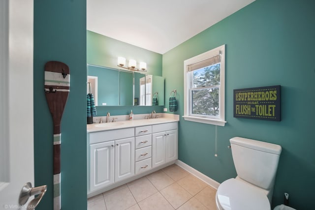 bathroom featuring vanity, tile patterned floors, and toilet