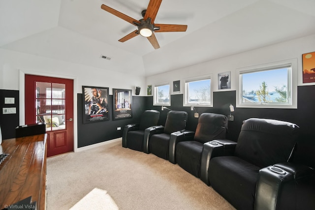 carpeted home theater with vaulted ceiling and ceiling fan