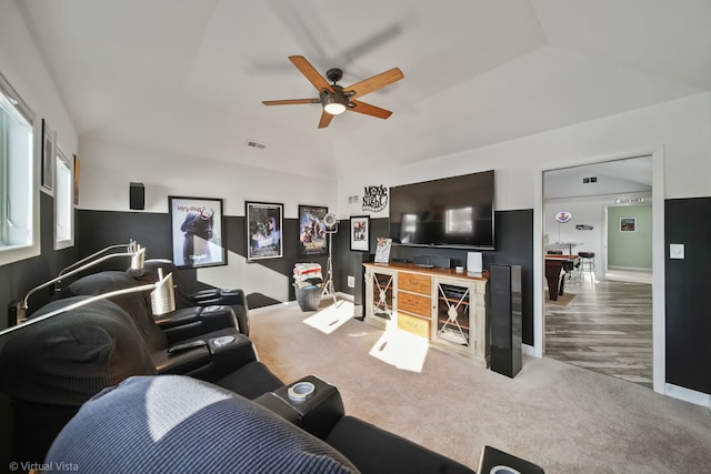 living room with lofted ceiling, carpet floors, and ceiling fan