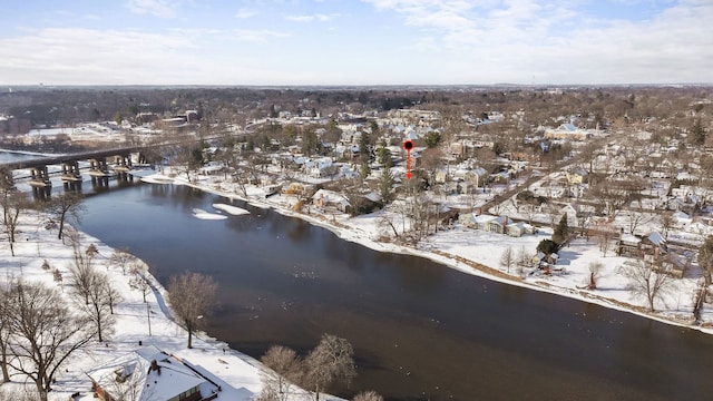 snowy aerial view with a water view