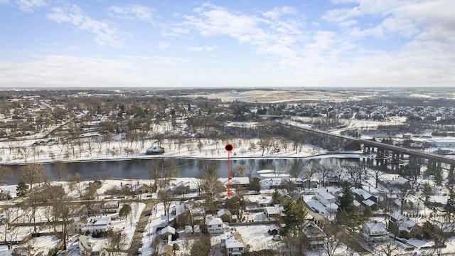 snowy aerial view with a water view