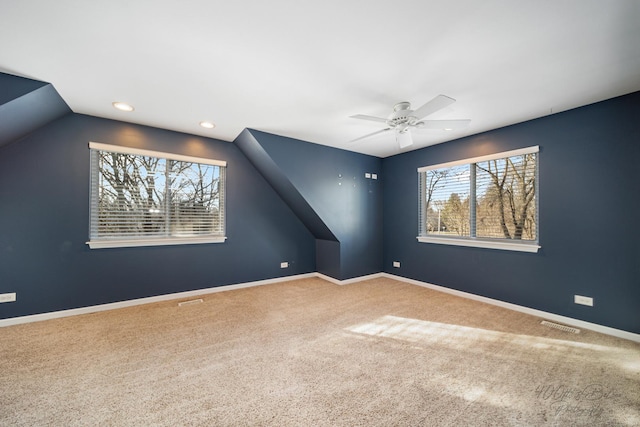 interior space featuring ceiling fan, lofted ceiling, and carpet floors