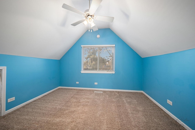 additional living space featuring vaulted ceiling, ceiling fan, and carpet flooring