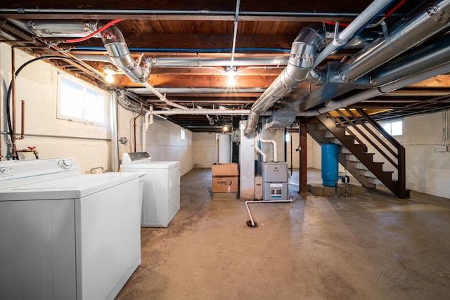 basement featuring heating unit and washer and dryer