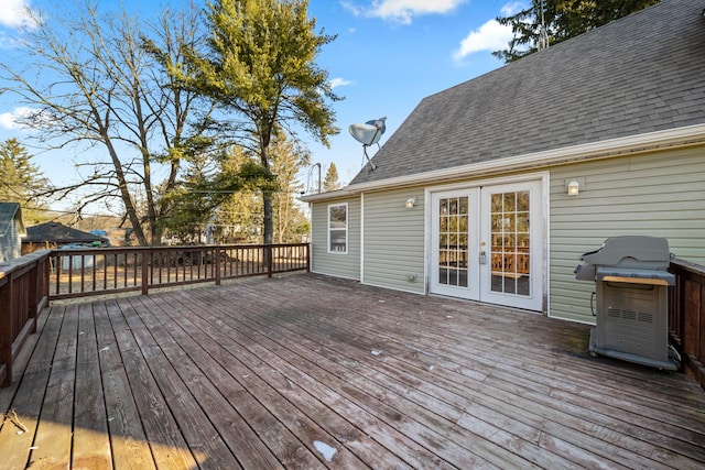 wooden deck featuring a grill and french doors