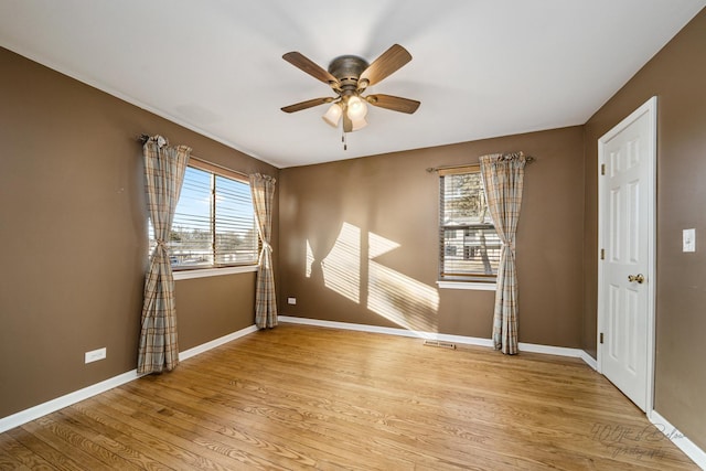 spare room with ceiling fan and light hardwood / wood-style flooring