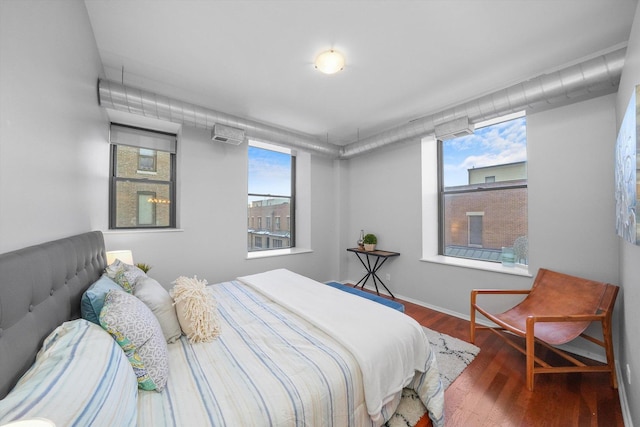 bedroom featuring wood-type flooring and multiple windows