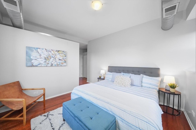 bedroom with dark hardwood / wood-style flooring