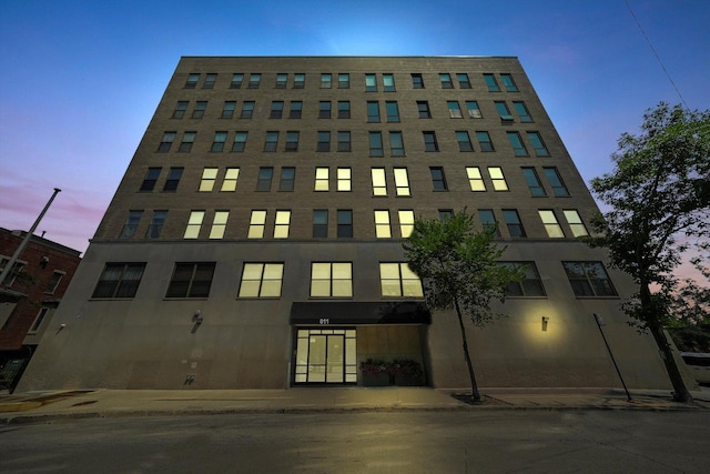 view of outdoor building at dusk