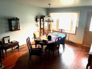 dining area with plenty of natural light and dark hardwood / wood-style floors